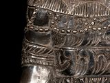a silver statue of a man with a hat on it ' s head