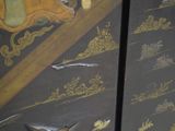 a close up of a painted cabinet with a bird on it