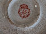 a white plate with a red lion on it