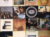 many different album covers on the wall of this room