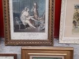 many framed pictures on the floor next to a red wall