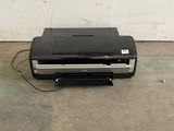 an image of a black and silver printer on the floor