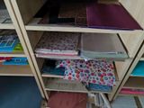 a wooden shelf with many different types of papers on it