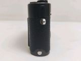 an image of a black leather camera case on a white surface