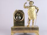 a statue of a man standing next to a clock