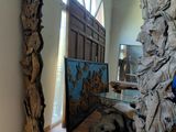 a large mirror made out of drift wood in a room
