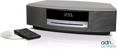 a clock that is on top of a radio with a remote