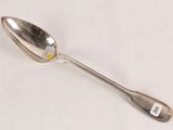 a spoon with a sticker on it sitting on a table