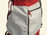 a red and white backpack with a flag on it