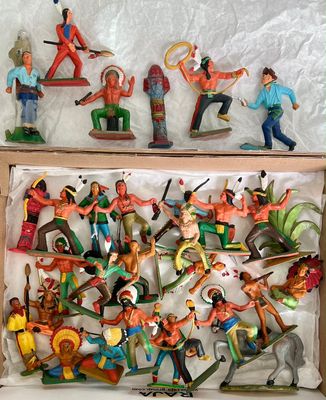 many figurines of different people in a box