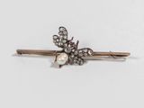 a close up of a hair pin with pearls on it