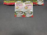 a close up of two packs of pokemon trading cards on a table