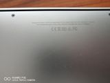 the back of a laptop with a battery on top of it