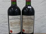 deux bouteilles de vin rouge posées sur une table en bois