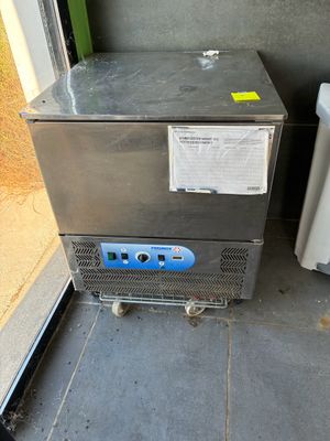 an image of a stainless steel refrigerator next to a glass door
