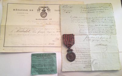 an old document with a red ribbon and a medal sitting on top of a table