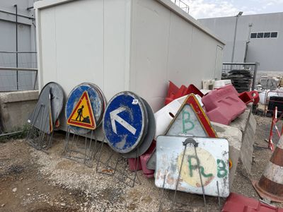 a lot of signs that are sitting on the ground