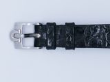 a close up of a black watch strap on a white surface