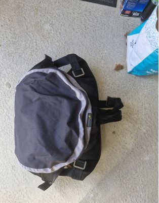 a backpack that is sitting on the floor next to a bag