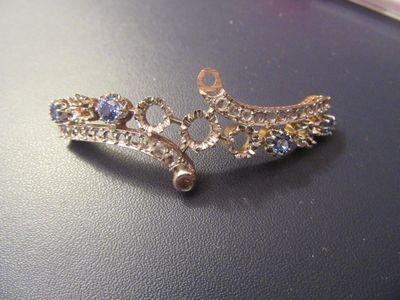 a picture of a pair of earrings that are on a table