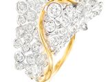 a close up of a diamond and gold ring on a white background