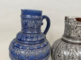 two vases sitting next to each other on a table