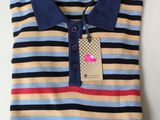 a close up of a striped polo shirt with a tag on it