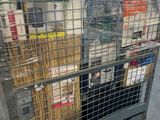 a metal cage with a bunch of items in it