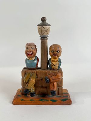a figurine of two people sitting on a bench