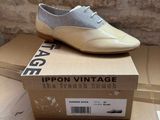 a pair of shoes sitting on top of a cardboard box