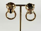 a pair of gold earrings with a lion head on them