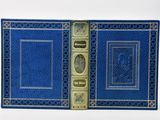 an old blue book with gold trim and a picture on the cover