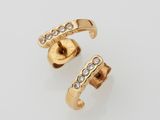 a pair of gold and diamond ear cuffs