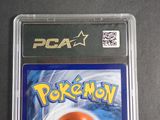 a pokemon card in a plastic case on a table