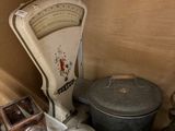 many pots and pans sitting on a shelf in a room