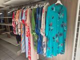a lot of clothes hanging on a rack in a store