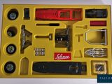 a yellow box with a toy car and other items in it