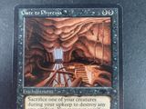 a close up of a card with a picture of a cave in the background