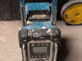 a radio that is sitting on the ground next to a wheel