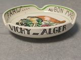 a small ashtray that has a picture of a bird on it