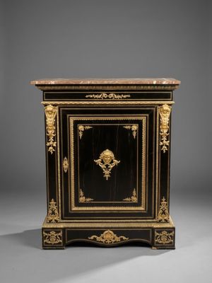 a black and gold painted cabinet with a lion head on the door