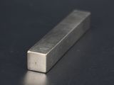 a close up of a block of metal on a black surface