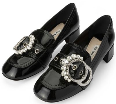 a close up of a pair of black shoes on a white background
