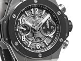 the watch is black and silver with a black rubber band
