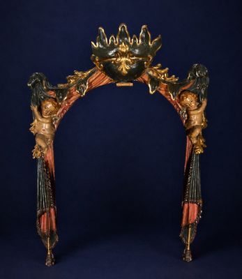 an image of a gold and red arch with statues on it