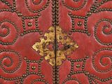 a close up of a red leather door with gold decorations