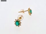 an image of a pair of emerald and diamond earrings on a white surface