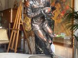 a statue of a man holding a baby on a table