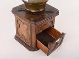 a small wooden box with a brass bowl on top
