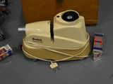 a yellow machine sitting on the floor next to a box